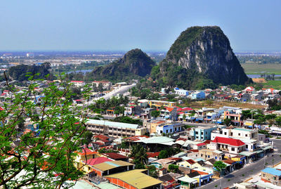 High angle view of townscape by sea against sky