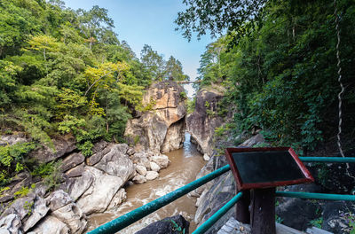 Wooden balcony and river stream going through rocky canyon op khan national park , chiang