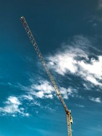 Low angle view of crane against sky