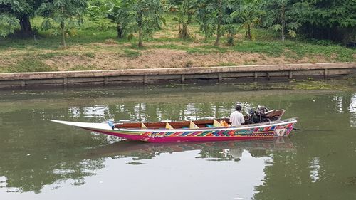 People in boat on lake