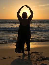 Full length of woman on beach during sunset