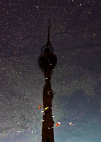 Close-up of water hanging against sky at night