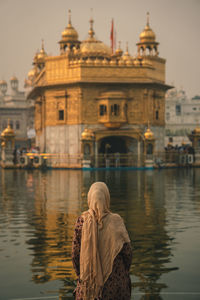 Rear view of woman on the river against sky