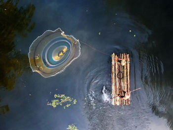High angle view of illuminated boat in lake at night