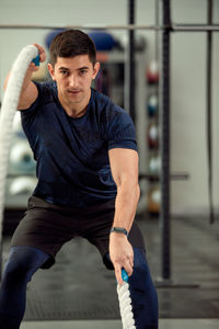 Portrait of young man exercising in gym