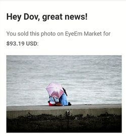 Boy on sea shore against sky