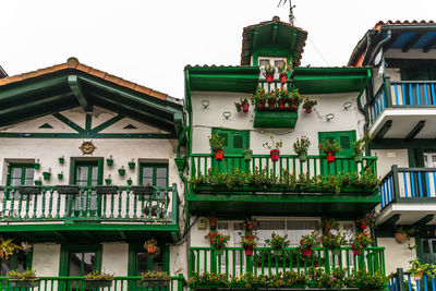 Traditional colorful fishermen houses in hondarribia decorate with flowers, spain