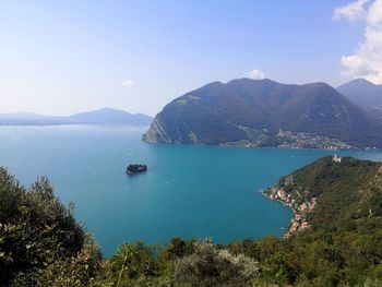 High angle view of bay and mountains against sky