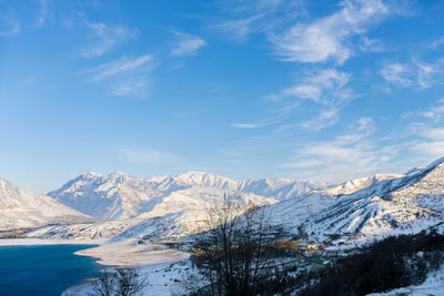 Beautiful snow-capped mountain peaks of the tien shan against the blue sky in winter