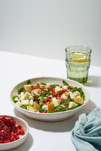 Fruits salad with nuts, balanced food, clean eating. spinach with apples, pecans and feta