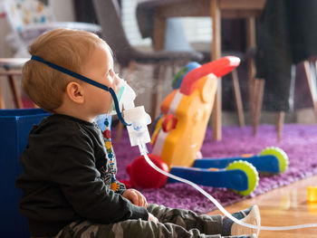 Side view of a boy playing with toy