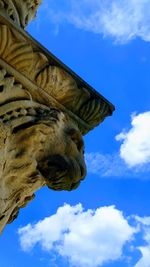 Low angle view of statue against blue sky