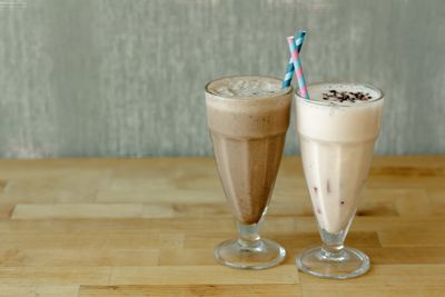 Close-up of glass of coffee with spoon on table