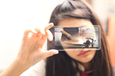 Close-up portrait of woman photographing