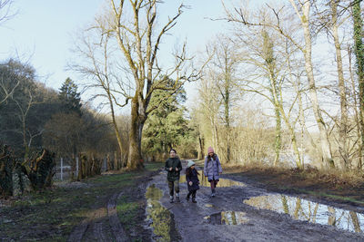 Rear view of people walking on road