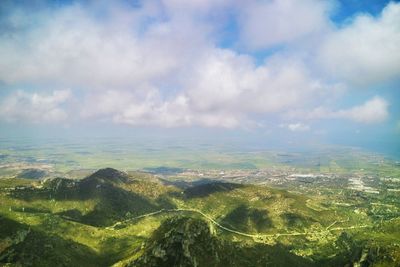 Aerial view of landscape against cloudy sky