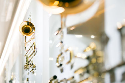 Low angle view of illuminated light bulbs hanging from ceiling