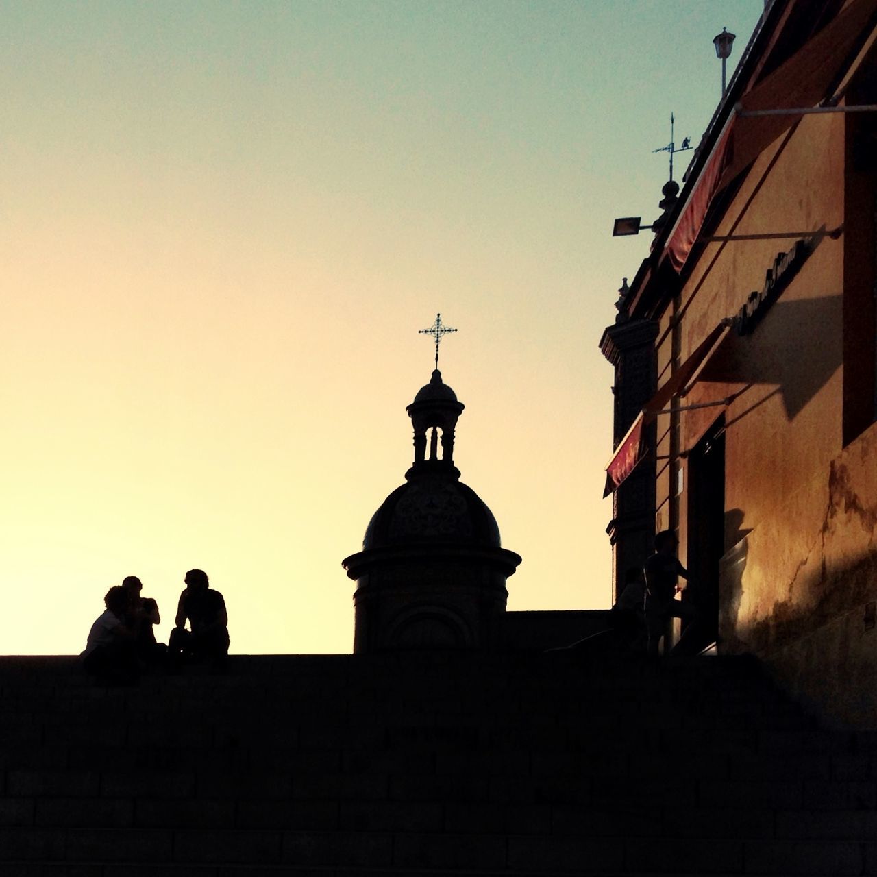 building exterior, architecture, built structure, clear sky, silhouette, sunset, men, copy space, lifestyles, place of worship, religion, person, leisure activity, church, spirituality, sky, low angle view, dusk