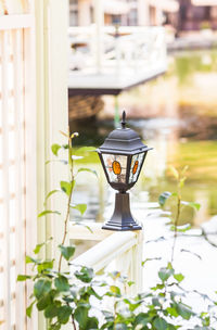 Close-up of small lantern on window