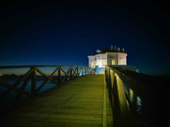 View of lighthouse against clear sky at night