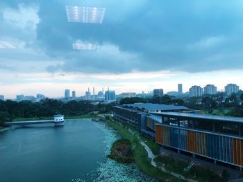 River amidst buildings in city against sky