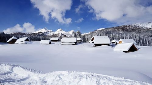 Snow covered field against sky