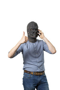 Full length portrait of young man standing against white background