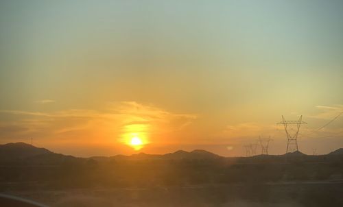 Scenic view of silhouette mountains against sky during sunset