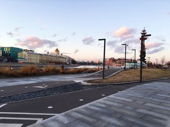 Road by city against sky