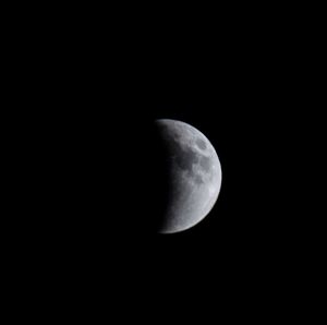 Low angle view of moon over black background