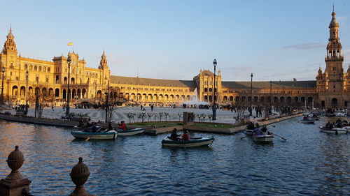 Boats in city against clear sky