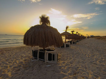 Scenic view of beach against sky during sunset