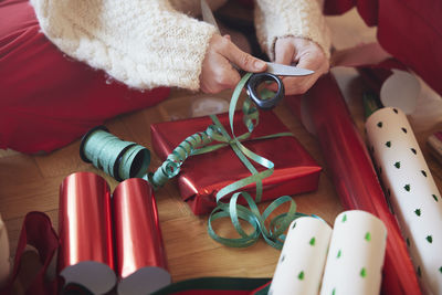 Woman's hands packing christmas presents