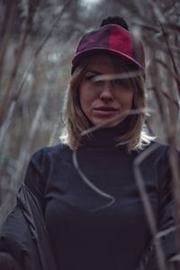 Portrait of woman standing amidst plants