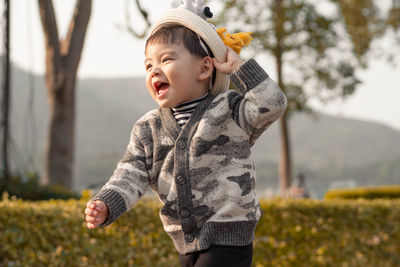 Cute baby boy looking away and running