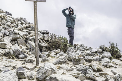Man photographing on rock
