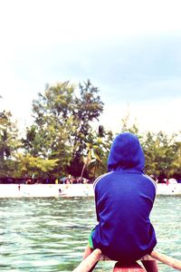 People standing on lake against sky