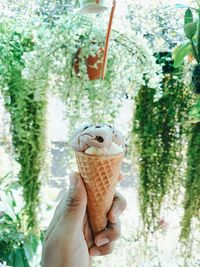 Close-up of hand holding ice cream