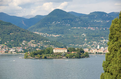 Scenic view of river by mountains against sky