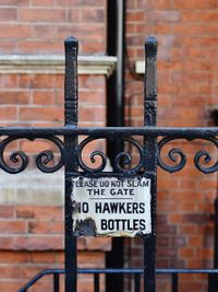 Close-up of text on metal gate