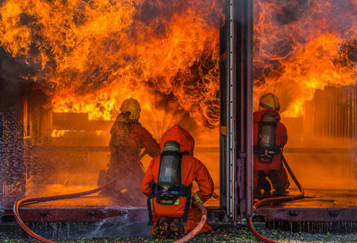 Firefighters spraying water on fire