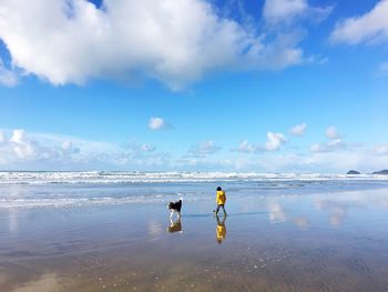 People on beach against sky