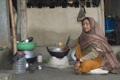 Portrait of woman preparing food at home