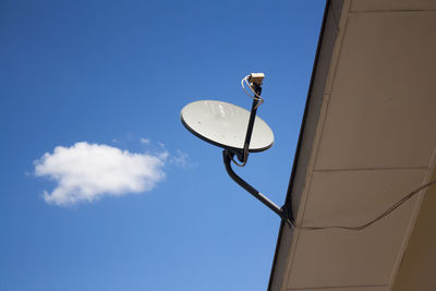 Low angle view of street light against blue sky