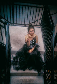 Portrait of a young woman sitting outdoors