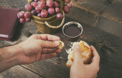 Midsection of person holding ice cream on table