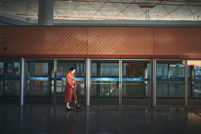 Full length of man standing in airport building