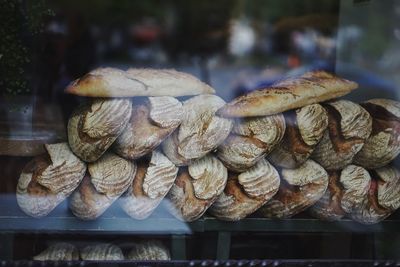 Baked breads at store seen through glass