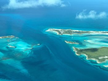 Aerial view of sea against blue sky