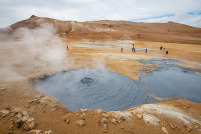 Scenic view of geyser against sky